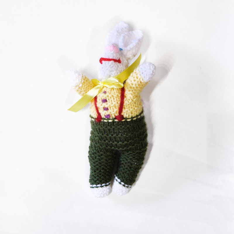 Knitted yellow and green doll, rabbit design, with yellow ribbon around the neck