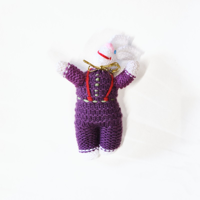Knitted purple doll, rabbit design, with gold ribbon around the neck