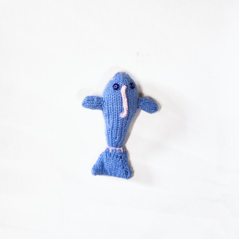 Knitted light blue doll, dolphin pattern